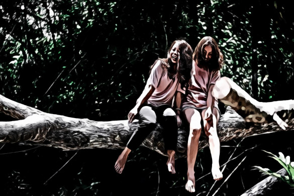 Two Woman Sitting on Tree Log