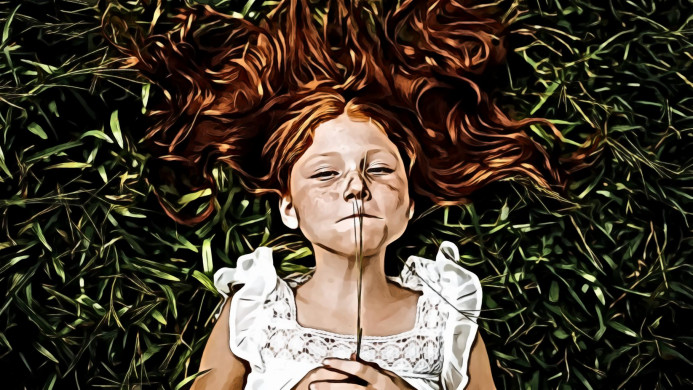 Girl Holding Plant While Lying on Grass