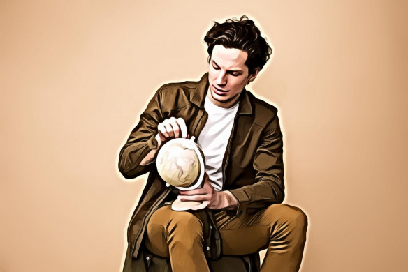 Man Sitting Holding White Desk Globe