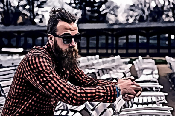 Man Wearing Black and Red Checkered Long Sleeve Shirt Wearing Black Wayfarer Sunglasses Sitting on White Wooden Chair