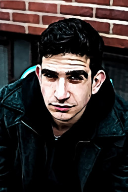 Man Wearing Dark Grey Jacket Sitting Near Brick Wall