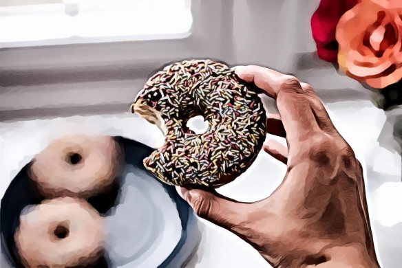 Person Holding Doughnut With Sprinkles