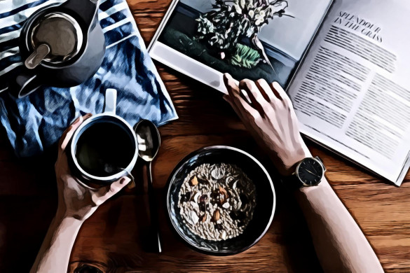 Person Holding White Ceramic Coffee Cup Leaning on Brown Wooden Table