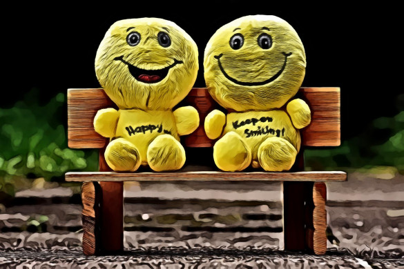 Two Yellow Plush Toys Sitting On Bench