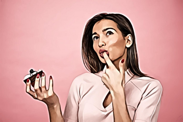 Woman Eating Cupcake While Standing Near Pink Background Inside Room