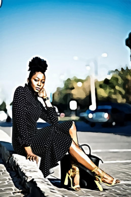 Woman in Black and White Polka-dot Dress Sitting Beside Pavement