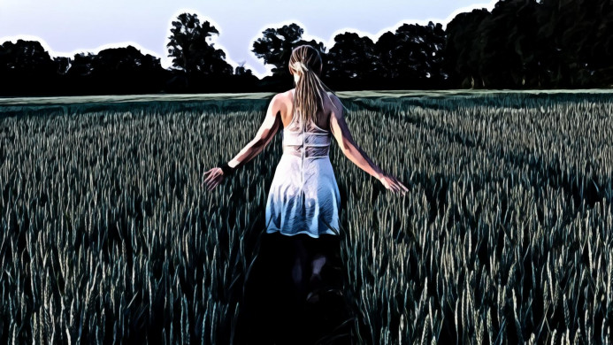 Woman in White Sleeveless Mini Dress Standing Between Grass Field
