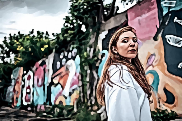 Woman Standing in Front of Wall With Mural