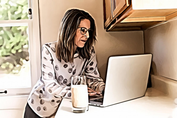 Woman Using Gray Laptop Computer in Kitchen