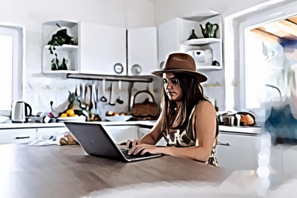 Woman Using Macbook In The Kitchen