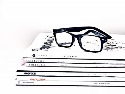 Blue Framed Eyeglasses on Seven Collective Books