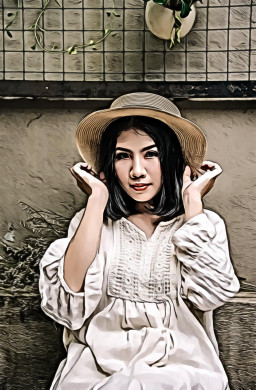 Woman Sitting While Holding Beige Straw Hat