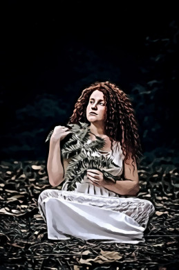 Portrait of Woman Sitting While Holding Green Leaves