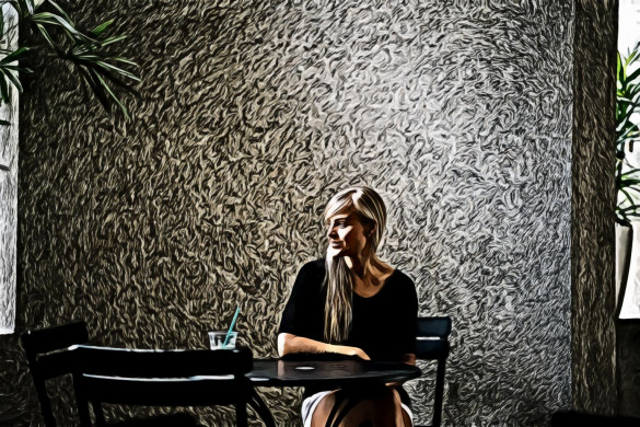 Woman in Black Scoop-neck Top Sitting on Black Metal Chair