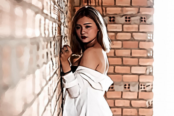 Woman in White Top Beside Red Brick Wall