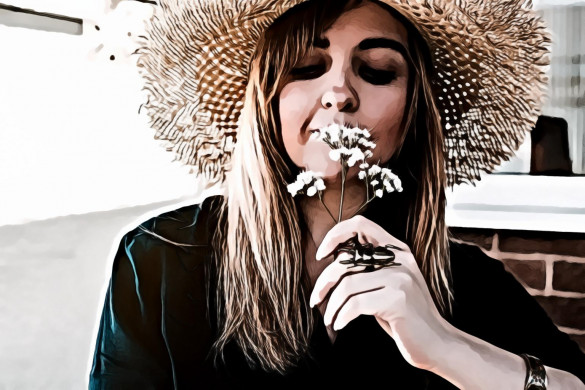 Woman Wearing Brown Sun Hat Smelling White Flowers