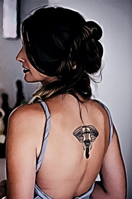 Woman with black elephant tattoo in back