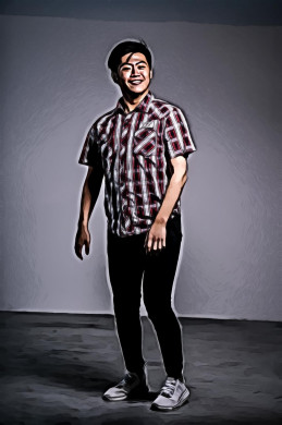 Man in red and white shirt standing beside wall