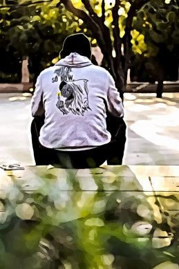 Man sitting alone on pavement