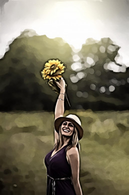 Smiling woman holding up bouquet of sunflowers