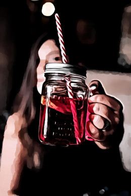 Woman holding red glass mason jar
