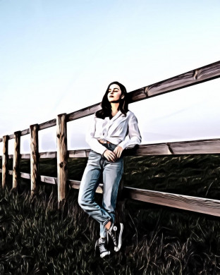 Woman leaning on wooden fence while standing on grass field