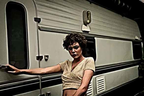 Woman standing beside camper trailer