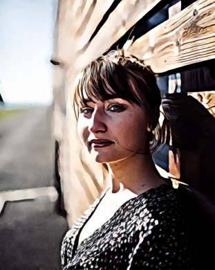 Woman standing in front of brown wooden wall