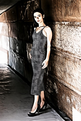 Woman wearing grey sleeveless dress standing near brown wall