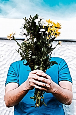 Person holding yellow petaled flowers