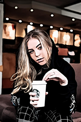 Sitting woman holding a starbucks to go cup
