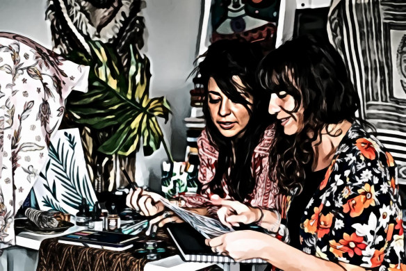 Two women sitting on chair