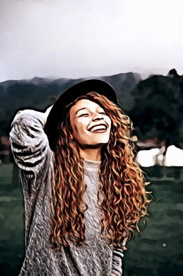 Woman holding her hat while smiling