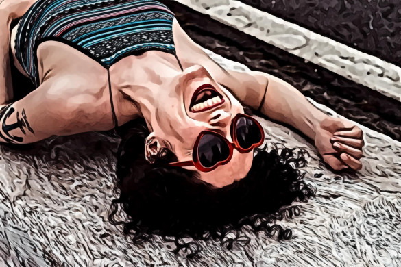 Woman laughing lying on concrete slab