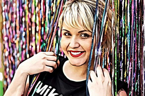 Woman leaning against wall full of sequin ropes