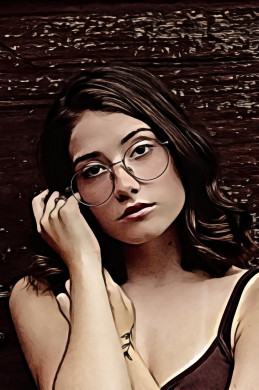 Woman wearing gray eyeglasses beside wall