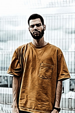 Man wearing orange crew neck shirt standing besides gray metal fence