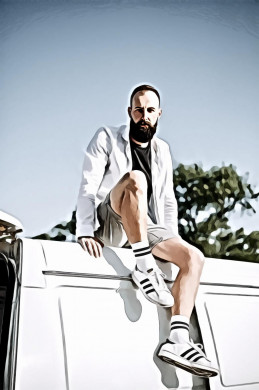 Portrait of a man in white long sleeves shirt sitting on white panel