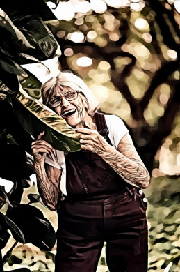 Woman smiling holding green leaf