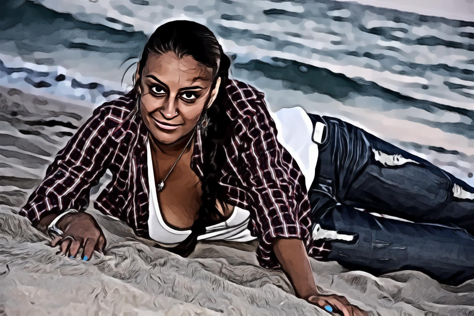 Beautiful Tan Girl Laying On Gray Sand