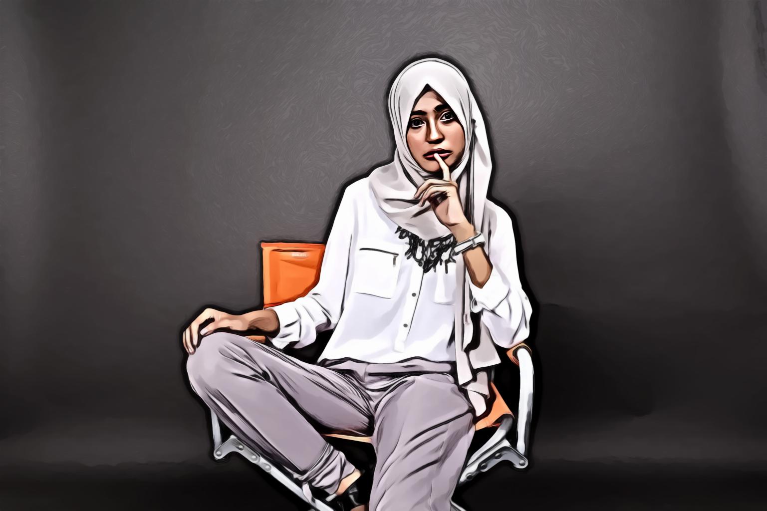 Woman Posing While Sitting on a Chair