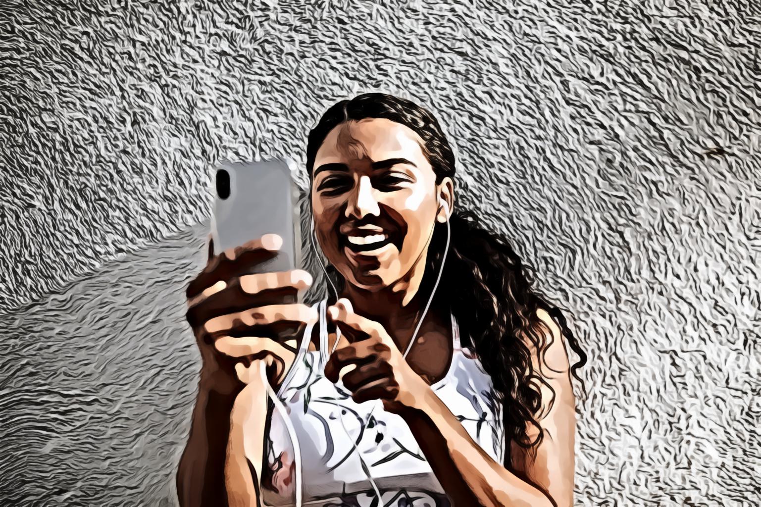 Woman Using Silver Iphone X While Leaning on Wall and Smiling