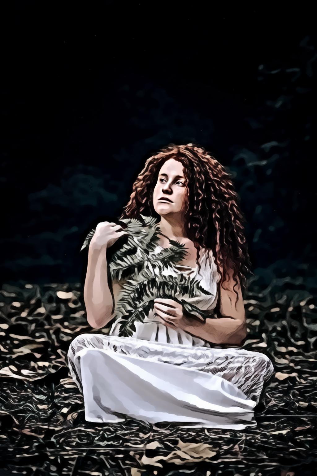 Portrait  of Woman Sitting While Holding Green Leaves