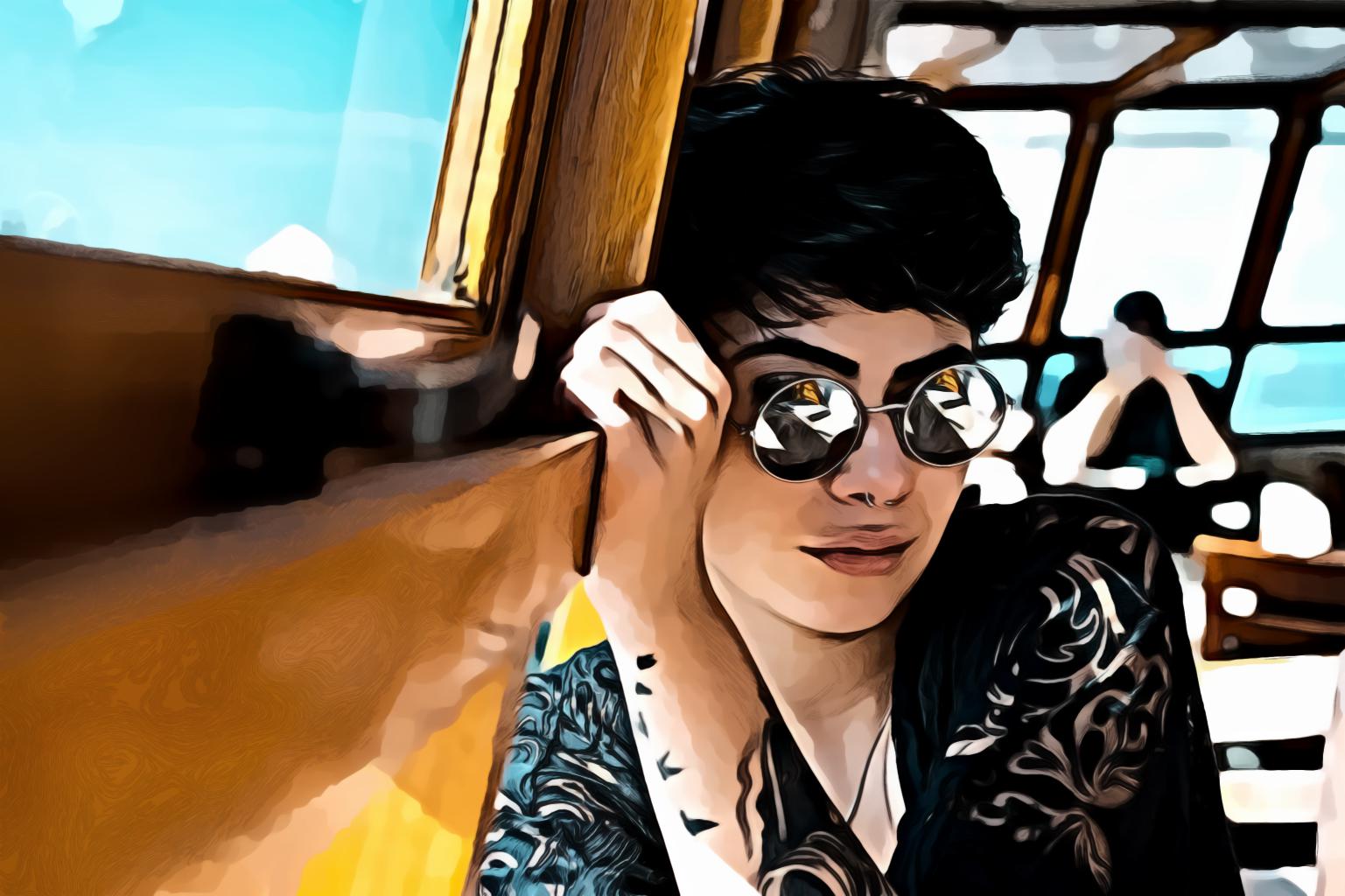 Shallow focus portrait of woman in black top wearing sunglasses